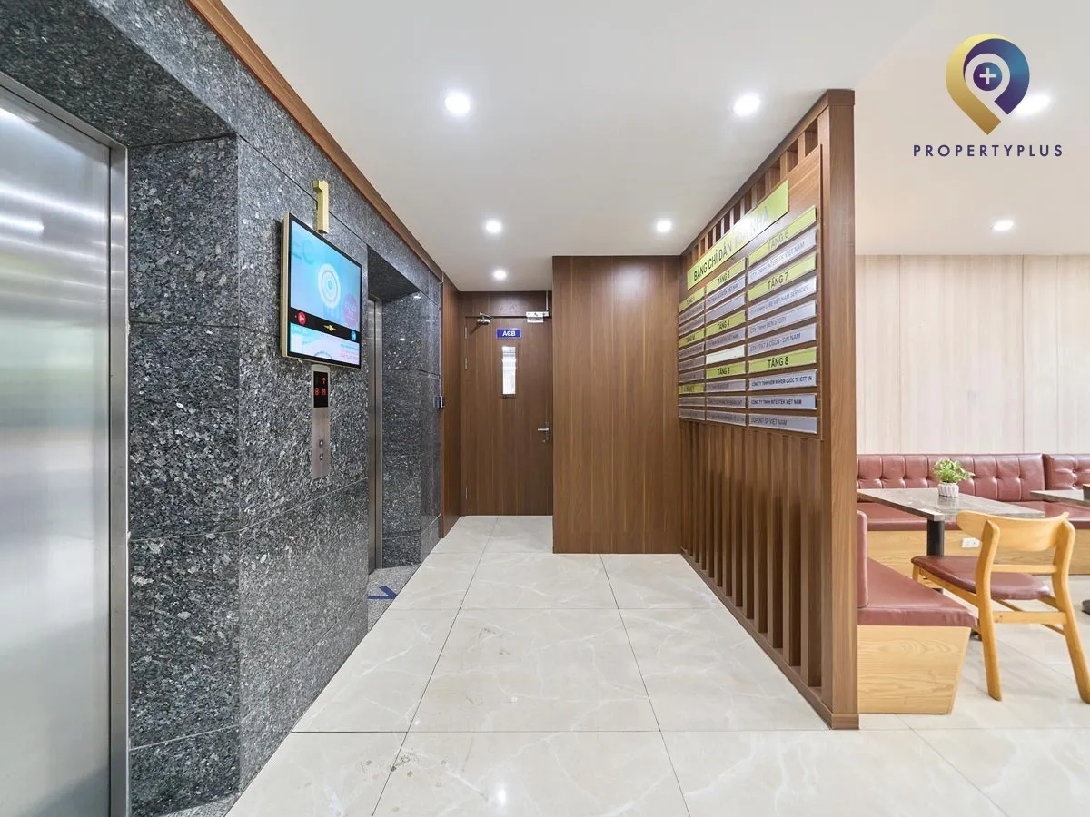 Ground floor lobby with wooden panel walls and elevator access in Au Viet Building